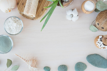 Beauty and fashion concept with spa setting. composition with Dead sea salt, coconut,  natural cosmetic blue clay,  soda, loofah. Flat lay, Spa concept with cotton flower, stones and towel. Copy space