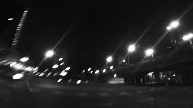 Urban time lapse with wide-angle of view. Shaky handheld fisheye lens clip. Blurry night street road traffic.