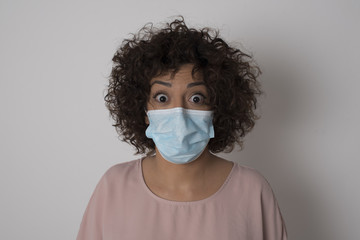 Headshot of goofy surprised bug-eyed young woman student wearing casual grey t-shirt staring at camera with shocked look, expressing astonishment and shock, screaming Omg or Wow