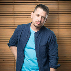 Young man wearing a blue outfit. Looking tired.