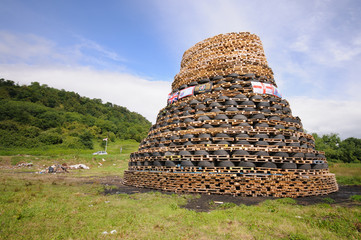 Traditional 11th 12th July bonfire in a protestant area of Northern Ireland made from pallets.