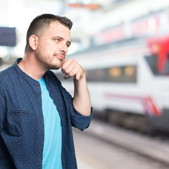 Young man wearing a blue outfit. Doing telephone gesture.