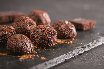 Dark chocolate and cherry candy on dark background