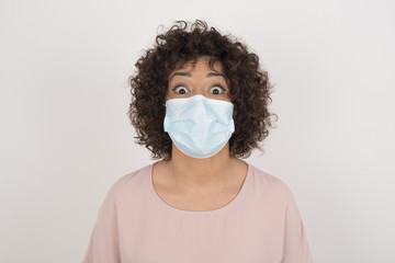 Young beautiful girl with an afro hairstyle having broad white smile being excited to meet Friends and go out to have a good day.