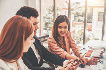 Business team sit at office desk and talking using digital tablet 