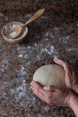 woman kneading bread at home