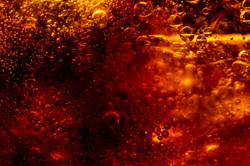 Close up view of the ice cubes in dark cola background. Texture of cooling sweet summer's drink...