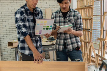 Carpenter working on wood craft at workshop to produce construction material or wooden furniture....