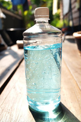 A bottle of Ethanol or ethyl alcohol Gel for based hand rub is highly effective in reducing influenza a virus on human hands in natural garden. Healthy and Covid-19 epidemic Concept.