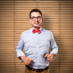 Man wearing a red bow tie. Looking happy.
