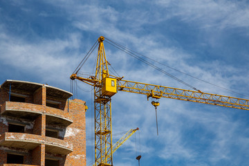 Work in progress on a new apartment block. Tall building under construction with cranes....