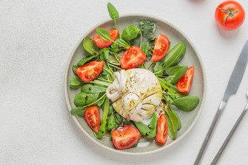Burrata cheese. Salad with Italian burrata cheese, balsamic and cherry tomatoes.