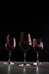 red wine in a wine glass with black background
