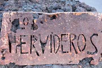 Los Hervideros rusty sign at coastline in Lanzarote island, Canary Islands, Spain