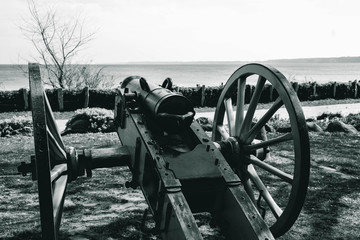 Fototapeta na wymiar black and white photo, an ancient cannon that shoots with cores rear view