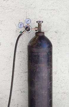 oxygen cylinder with liquefied oxygen, pressure sensors and a hose on a white background. Vintage oxygen cylinder