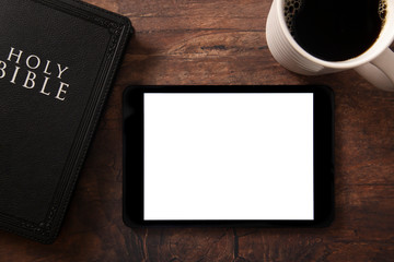 A Bible and Coffee with a White Tablet on a Wooden Table to Add your Text