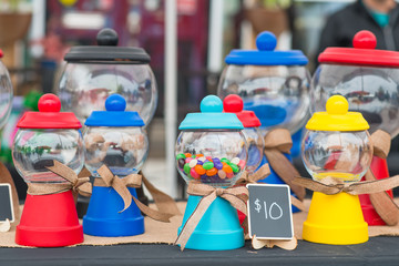 Naklejka premium Homemade Gumball Machines at a City Market