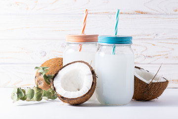 Organic coconut water in mason jar on the table. Healthy non dairy drink. 