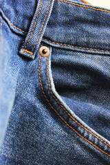 Naklejka premium Blue denim jeans texture close up view. Classic dark blue denim jeans background. Jeans fabric front, casual pants close up