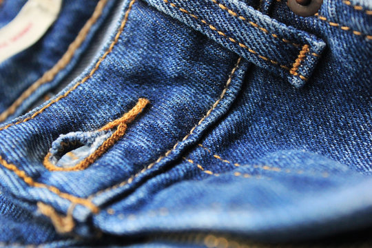 Denim Jeans Detail With Undone Button Hole Close Up. Dark Blue Stylish Jeans Fabric Design With Undone Button, Casual Stylish Pants 