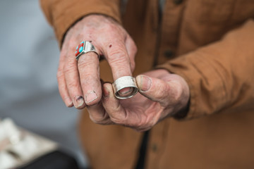 Maker holding a Handmade Coin Ring at a City Market