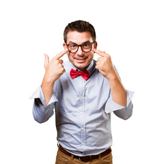 Man wearing a red bow tie. Pointing to his eyes.