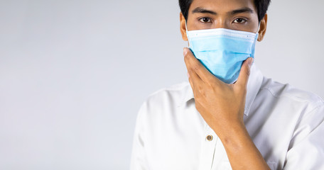 Fototapeta na wymiar Studio portrait of Asian woman wearing face medical surgical mask, looking at camera, isolated on white background. Mask protection against virus. Covid-19, coronavirus pandemic