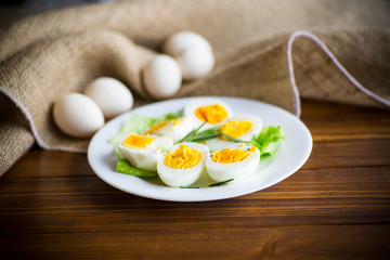 boiled eggs with salad leaves in a plate