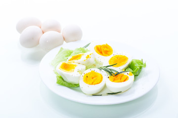 boiled eggs with salad leaves in a plate