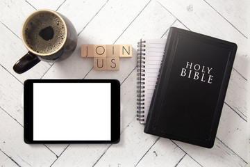 Join Us in Block Letters on a White Wooden Table with a Bible and Tablet