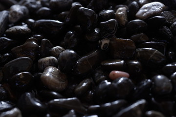 Black Dark Pebbles For Background or Texture Moody Wet Stone surface gloomy
abstract muted colors