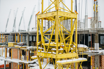 Fototapeta na wymiar the construction of new walls in the construction of a residential building with a crane
