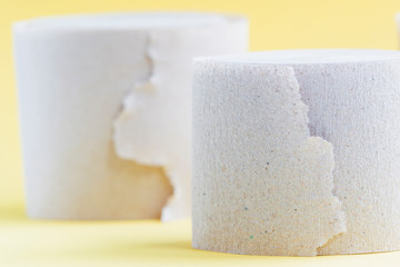 Toilet paper on a yellow background.