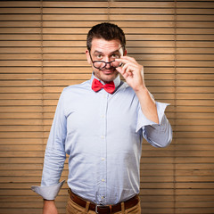 Man wearing a red bow tie. Looking over glasses.