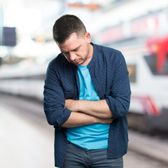 Young man wearing a blue outfit. Looking sad.