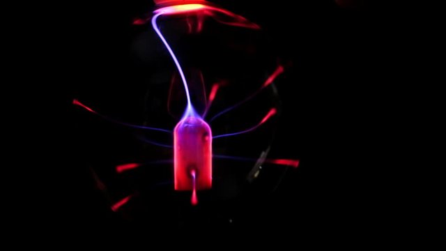 Plasma ball lamp, Tesla Coil experiment with electricity, plasma lamp close-up. Beautiful Abstract backdrop, Disco lights background. 4k video. dark.