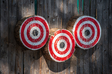 Round wooden targets on wooden wall