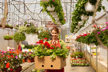 Attractive young woman in a flower center.