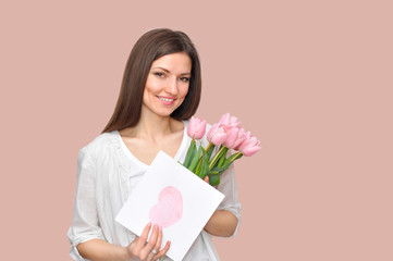 Beautiful woman mommy smiling with flowers and gift.Mother's day holiday.	