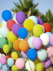 Fototapeta na wymiar Colorful balloons in summer. Concept of diversity, cheerfulness and light-heartedness