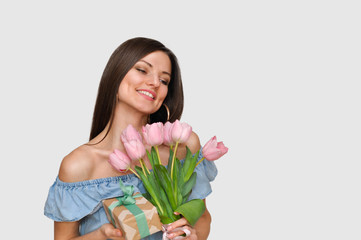 Beautiful sexy woman  smiling with pink tulip flowers .Mother's day holiday.	