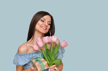 Beautiful sexy woman  smiling with pink tulip flowers .Mother's day holiday.	