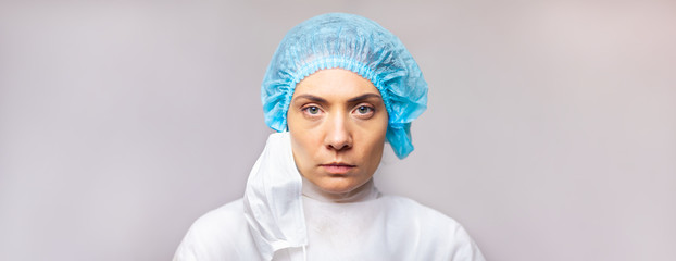 serious look woman doctor in medical uniform is looking at the camera, close-up portrait. copy space. space for text or logo