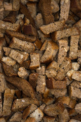crackers are scattered on a cotton cloth for salad beer snacks with garlic and cereals from rye bread with seeds