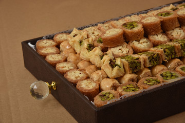 Ramadan Arabic desserts (Kunafa and Baklava) decorated in a brown gift box