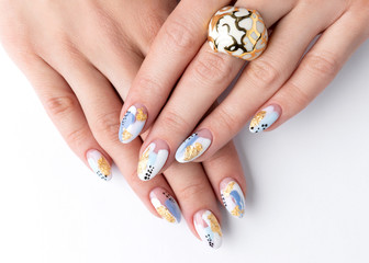 Young adult woman's hands with fashionable nails on white background