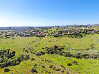 Aerial view of green valley with big luxury villa on the background in a private community, San Diego, California.