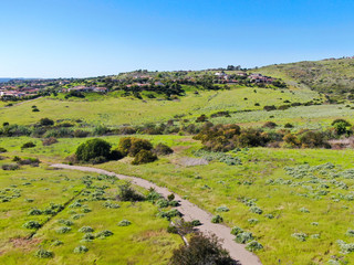 Fototapeta na wymiar Aerial view of green valley with big luxury villa on the background in a private community, San Diego, California.