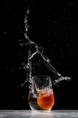 tomato water splash in a drinking glass